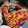 Hand-crocheted Viola Bag in bright yellow and magenta Italian Lycra Fetucia yarn with a pearl handle – limited edition designer accessory by InaPavl.