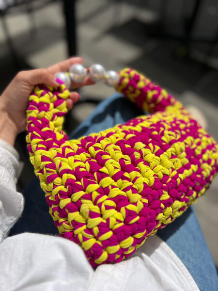 Hand-crocheted Viola Bag in bright yellow and magenta Italian Lycra Fetucia yarn with a pearl handle – limited edition designer accessory by InaPavl.