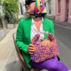 Handmade crochet Viola bag in vibrant purple and orange, crafted from Italian Lycra Fetucia yarn with a pearl handle – limited edition designer accessory by InaPavl.