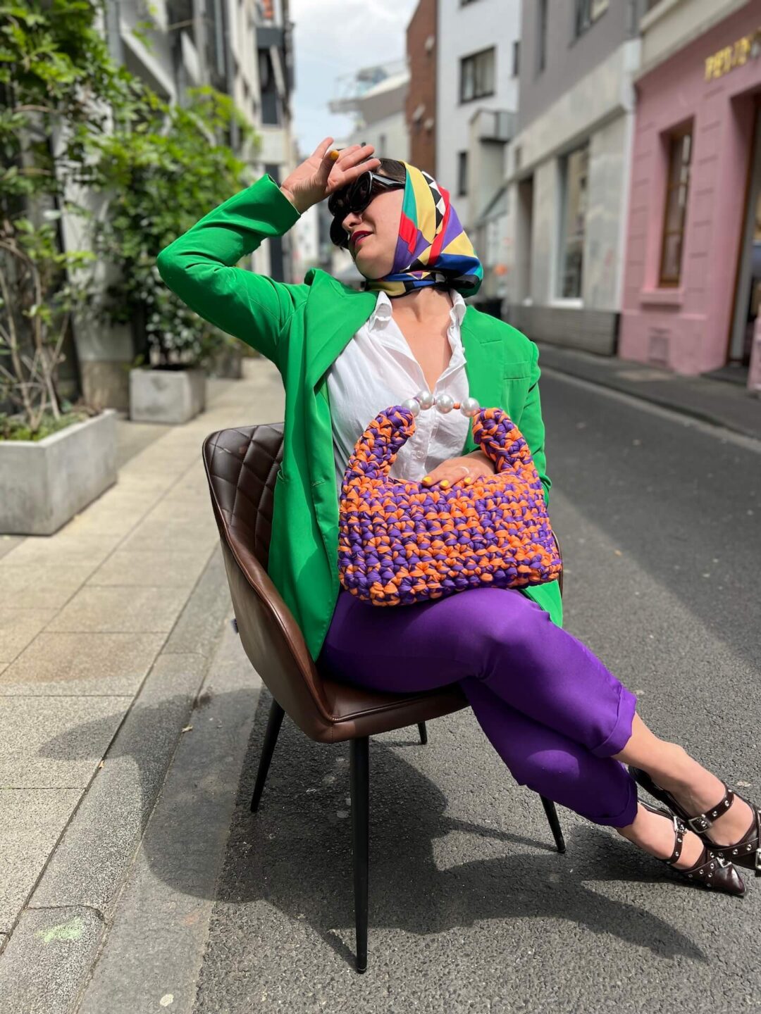 Handmade crochet Viola bag in vibrant purple and orange, crafted from Italian Lycra Fetucia yarn with a pearl handle – limited edition designer accessory by InaPavl.