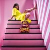 Hand-crocheted Viola Bag in bright yellow and magenta Italian Lycra Fetucia yarn with a pearl handle – limited edition designer accessory by InaPavl.
