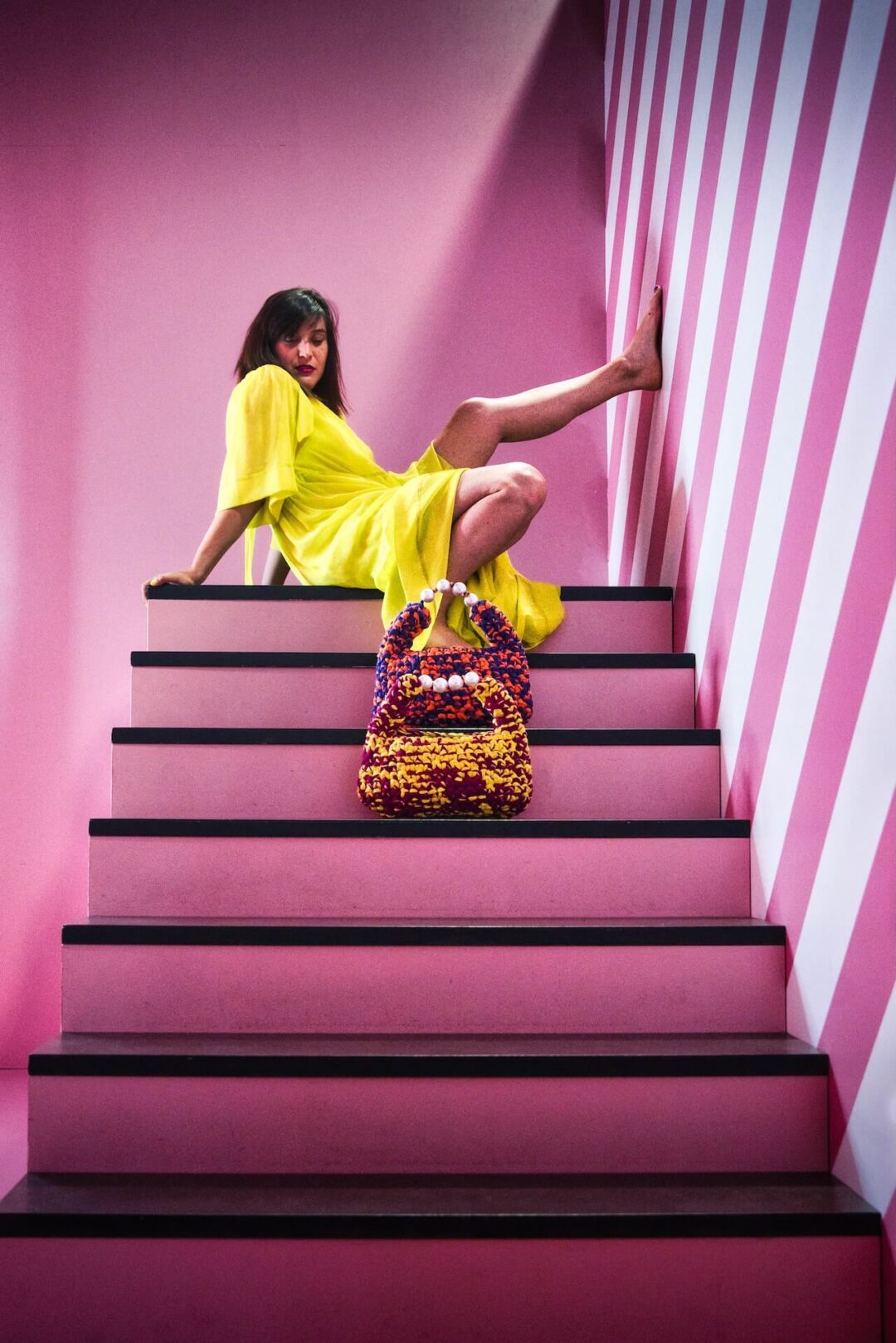 Hand-crocheted Viola Bag in bright yellow and magenta Italian Lycra Fetucia yarn with a pearl handle – limited edition designer accessory by InaPavl.