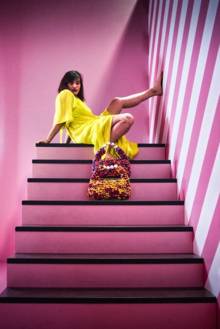 Hand-crocheted Viola Bag in bright yellow and magenta Italian Lycra Fetucia yarn with a pearl handle – limited edition designer accessory by InaPavl.